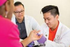  PharmD student with patient at clinic