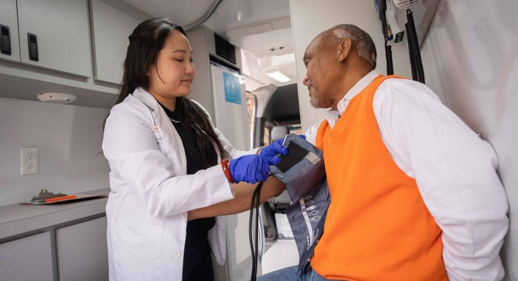 doctor of pharmacy student with patient in mobile clinic van