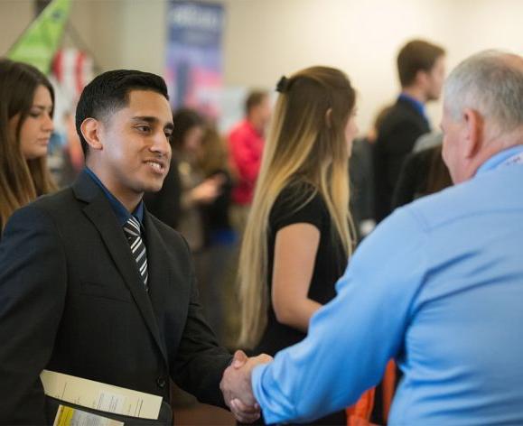 University of the Pacific graduate students network with potential employers on the Stockton campus.